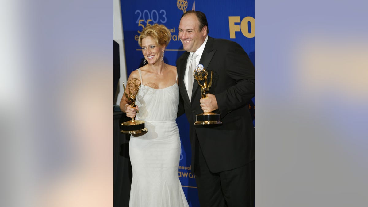 Edie Falco and James Gandolfini holding Emmys backstage at the Emmy Awards