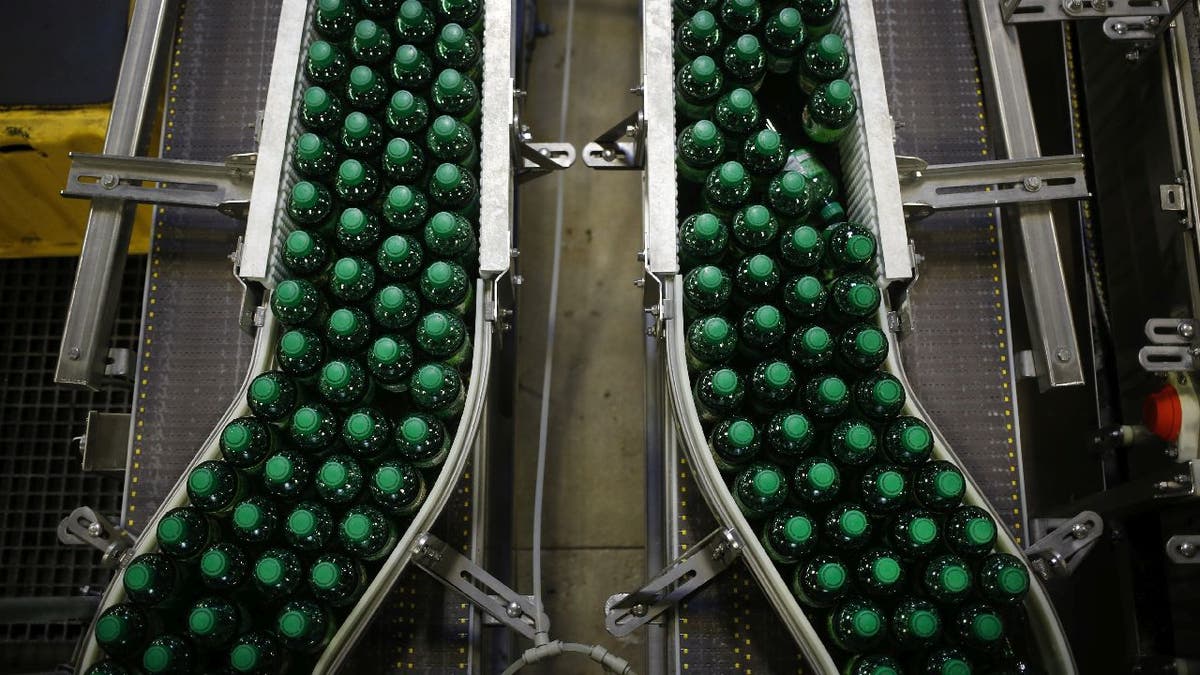 Canada Dry Ginger Ale bottles on a factory conveyor belt.