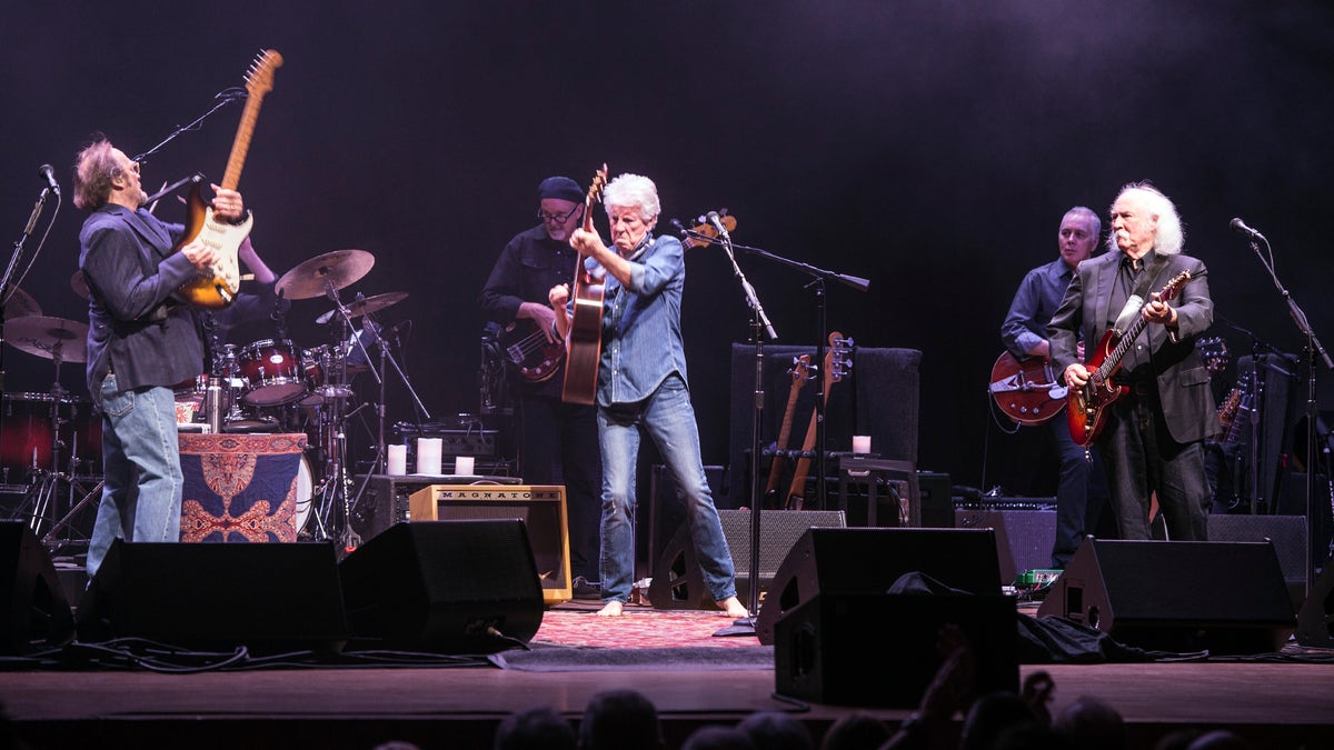 Stephen Stills, Graham Nash, and David Crosby perform on stage in England as Crosby Still & Nash