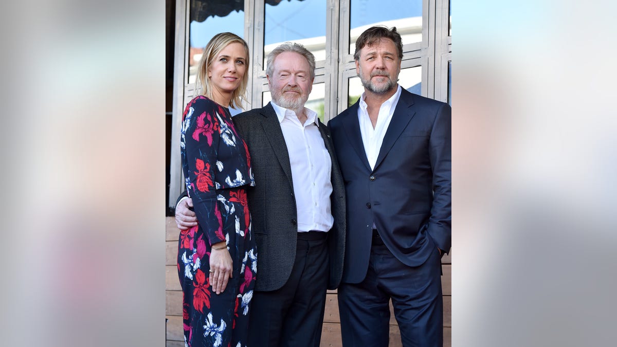 Kristen Wiig, Ridley Scott, and Russell Crowe pose together at Hollywood Walk of Fame