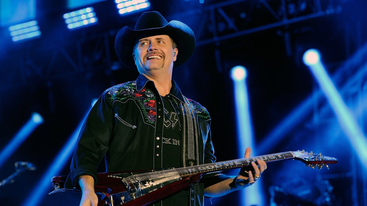 John Rich smiles at a photo taken during a performance.