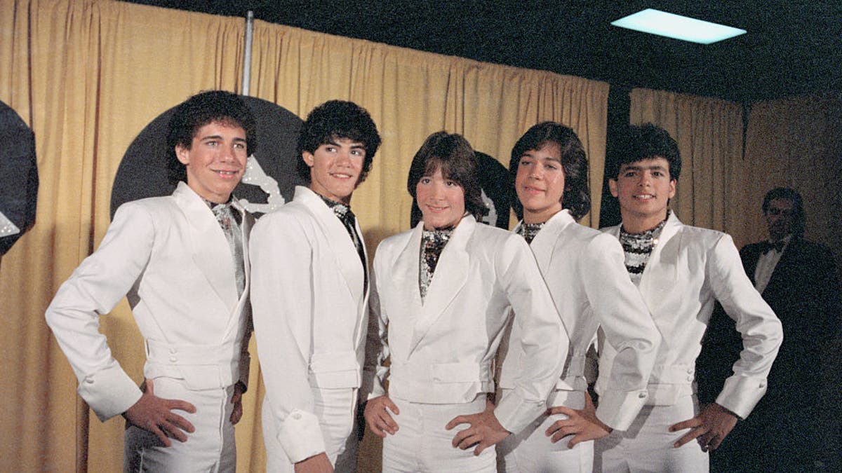 Ricky Melendez, Charlie Masso, Roy Rosello, Rey Reyes, and Robi Rosa of Menudo present award for "Best Recording for Children" at the 1984 Grammy Awards.