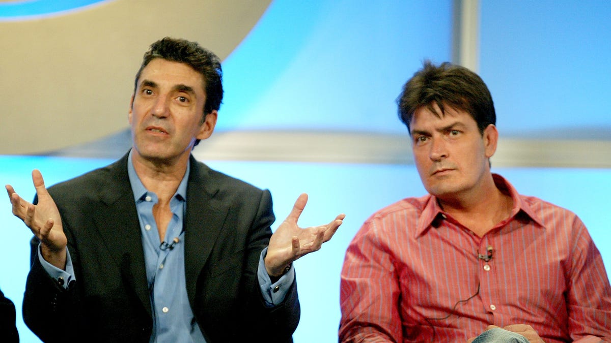 Chuck Lorre and Charlie Sheen sit next together on stage