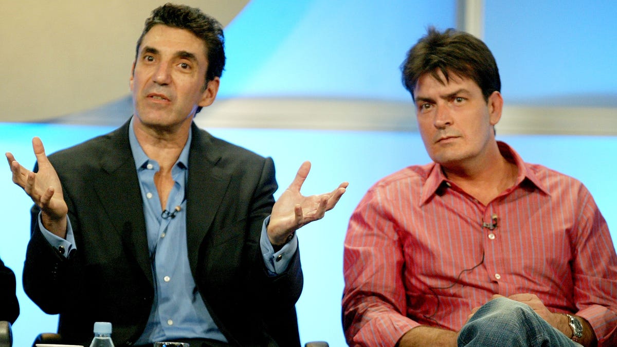 Chuck Lorre and Charlie Sheen sit next together on stage