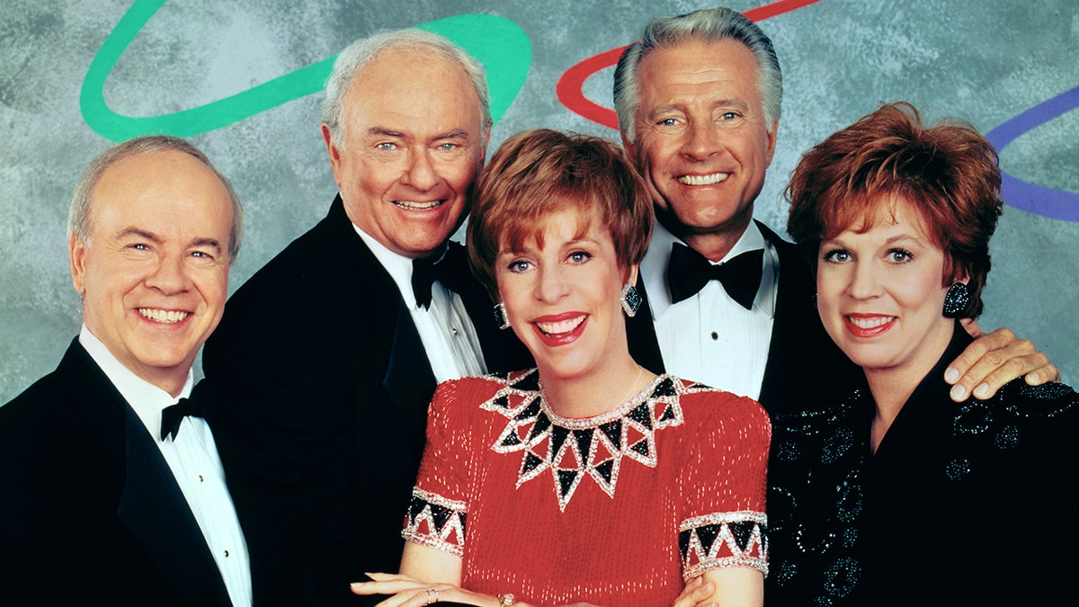 The Carol Burnett Show cast smiling while standing close to each other