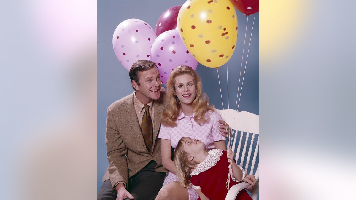 Dick Sargent, Erin Murphy and Elizabeth Montgomery posing next to balloons