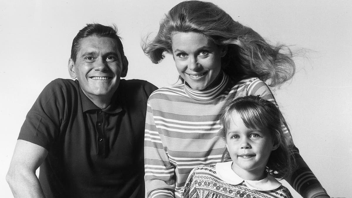Dick York, Elizabeth Montgomery and Erin Murphy riding bikes in a black and white photo