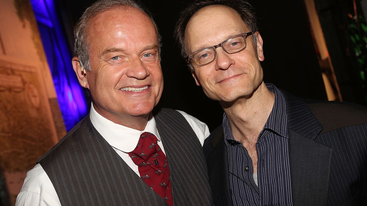 Kelsey Grammer embracing David Hyde Pierce for a photo