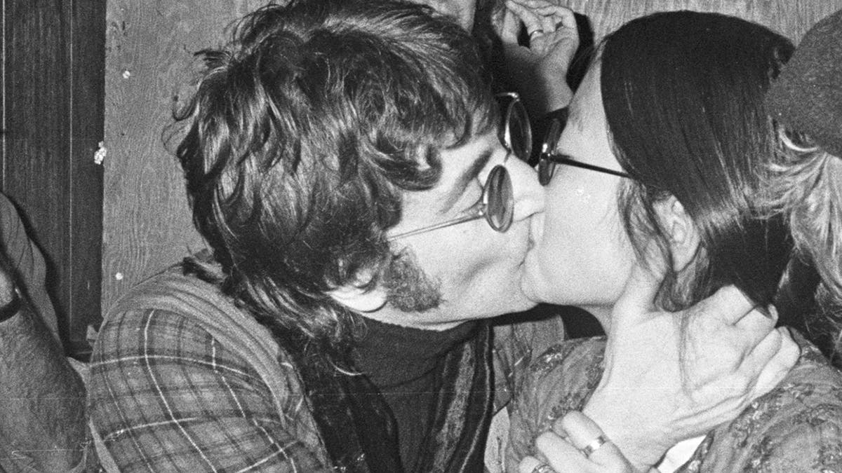 Close-up of John Lennon kissing May Pang