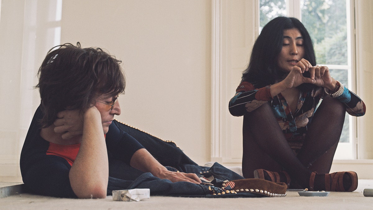 John Lennon and Yoko ono sitting on the floor