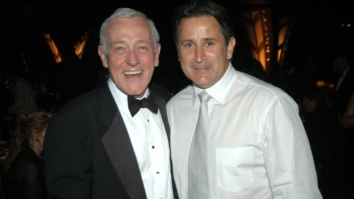 John Mahoney in a tux smiling next to Anthony LaPaglia wearing a white shirt