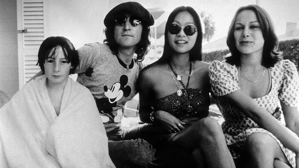 John Lennon posing for a photo with Julian Lennon, May Pang and Cynthia Lennon