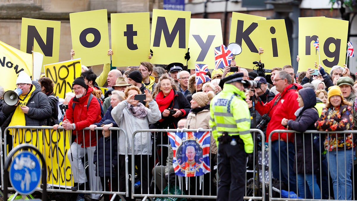 Protestors holding yellow not my king signs