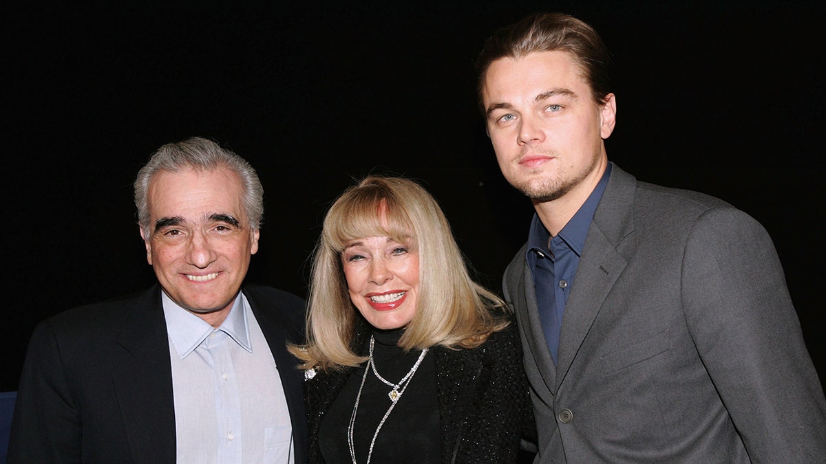 Martin Scorsese, Terry Moore and Leonardo DiCaprio posing in front of a camera
