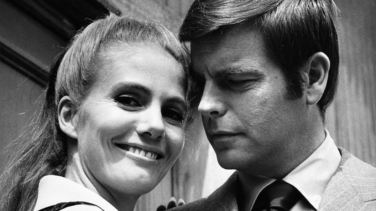 A close-up black and white photo of Sharon Acker and Robert Wagner