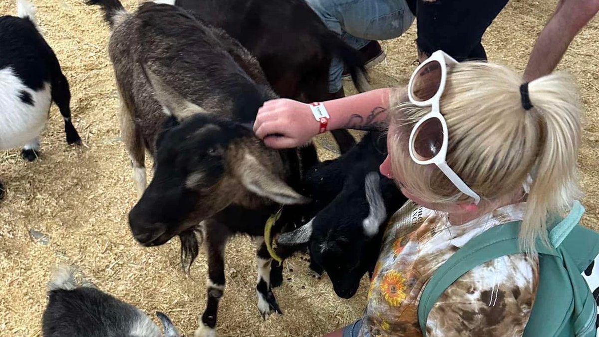 Gillis petting a goat