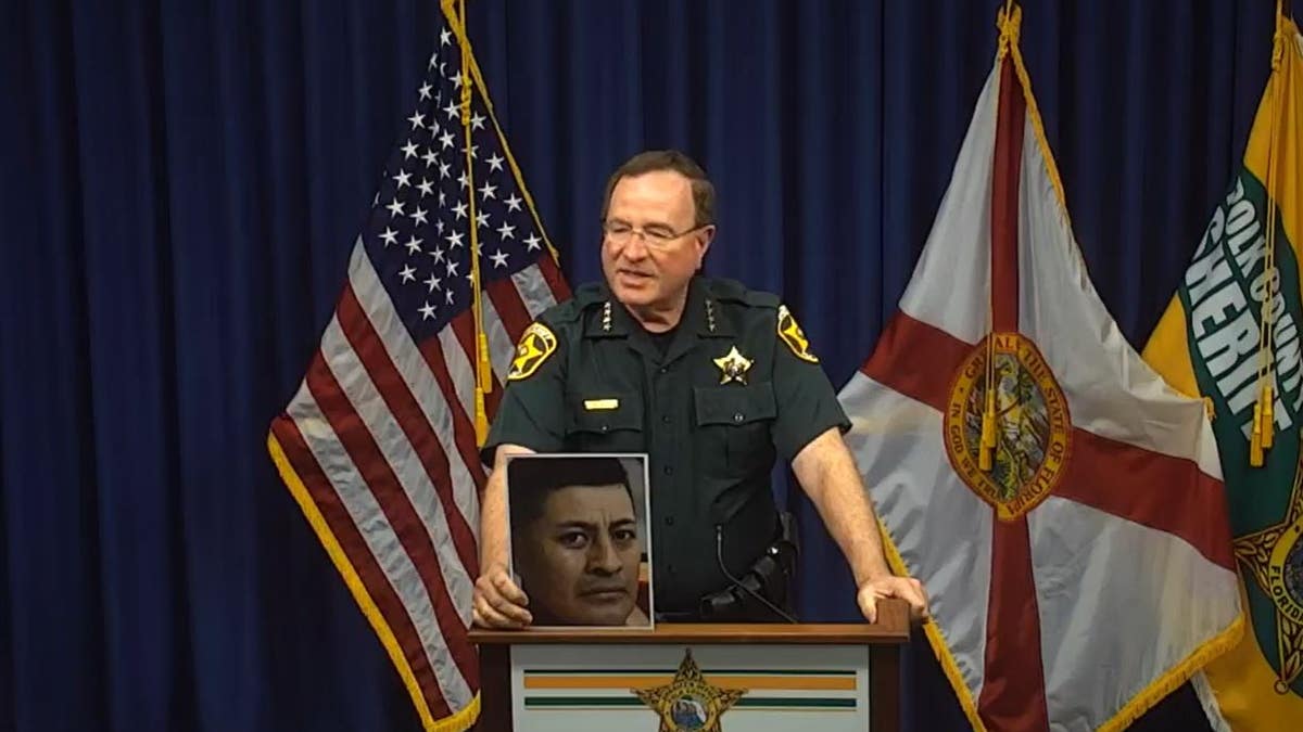 Polk County Sheriff (FL) Grady Judd holds picture of inmate who died