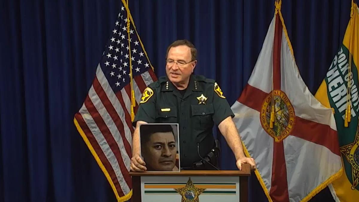 Polk County Sheriff (FL) Grady Judd holds picture of inmate who died