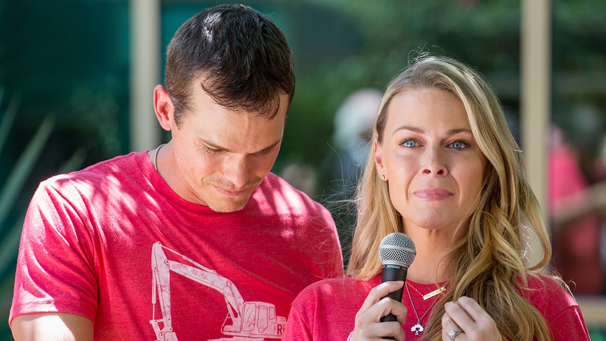 Granger Smith and his wife Amber Smith in tears while wearing red shirts