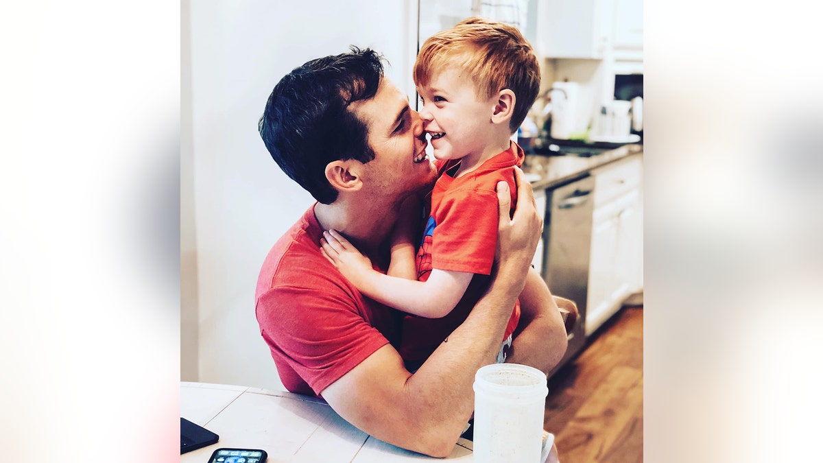 Granger Smith embracing his son River