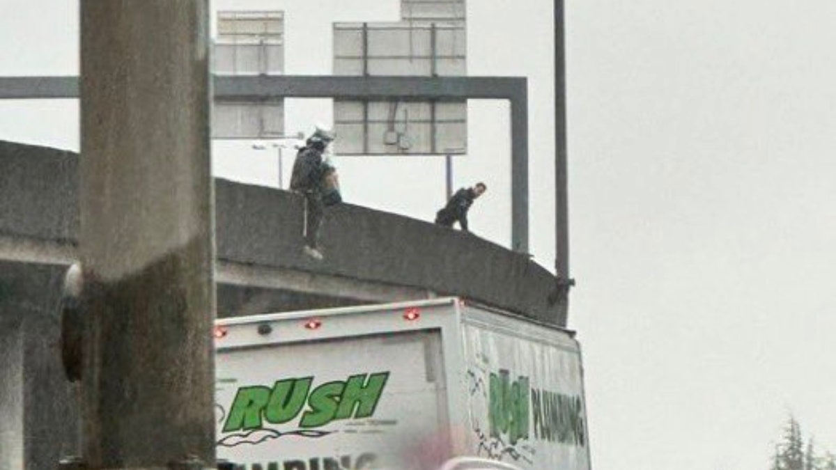 Homeless woman dangling from bridge