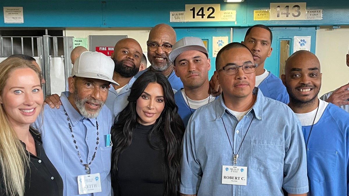Kim Kardashian poses with several of the inmates