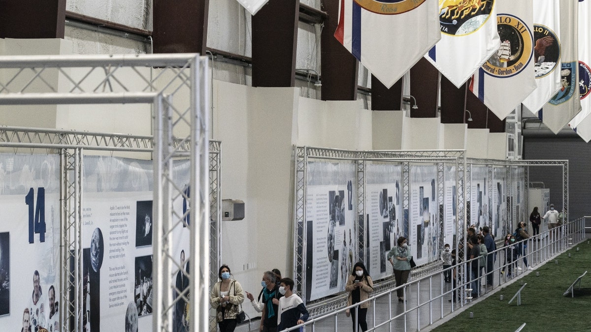 Visitors tour the Saturn V rocket exhibit at the NASA Johnson Space Center