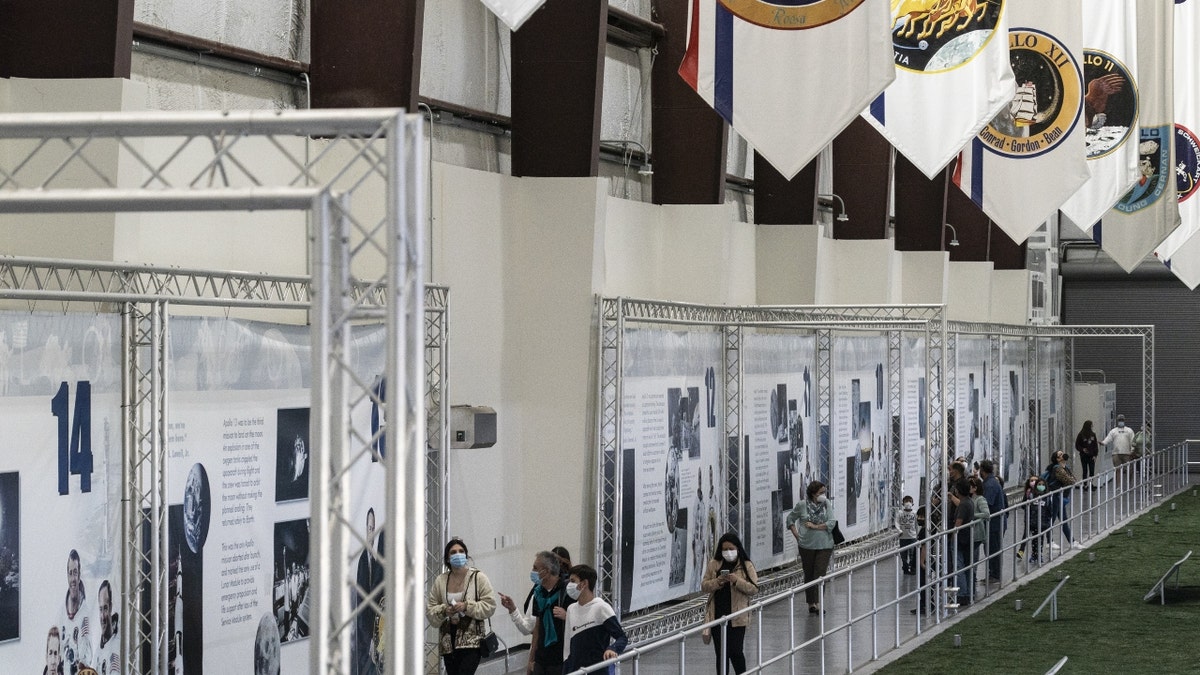 Visitors tour the Saturn V rocket exhibit at the NASA Johnson Space Center 