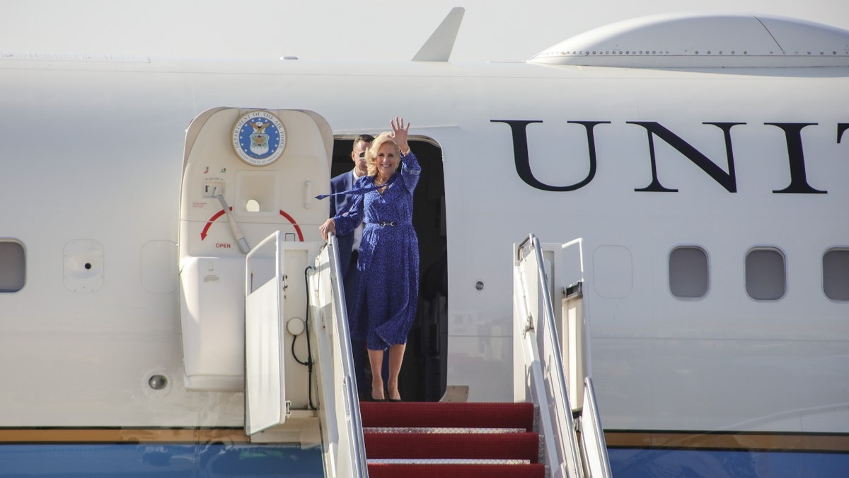 First lady Jill Biden exits the Executive One Foxtrot and waves