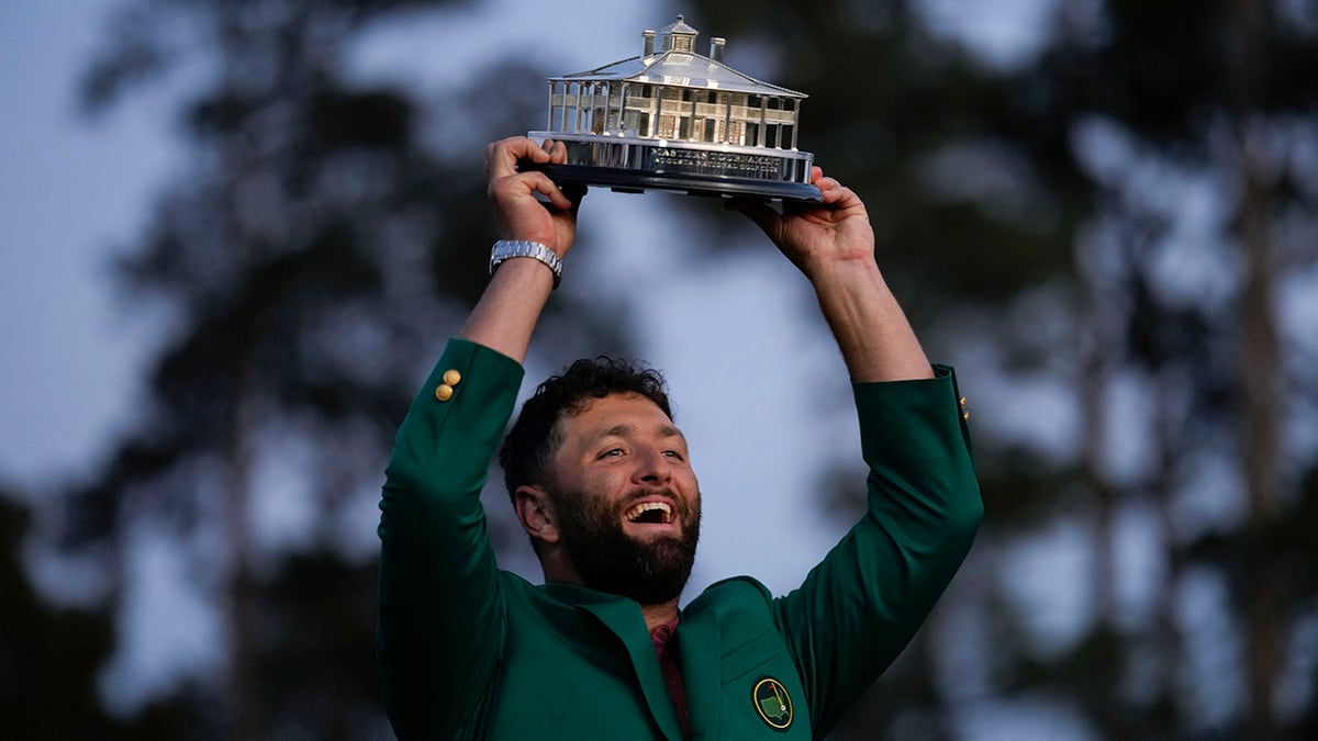 Jon Rahm holds the trophy