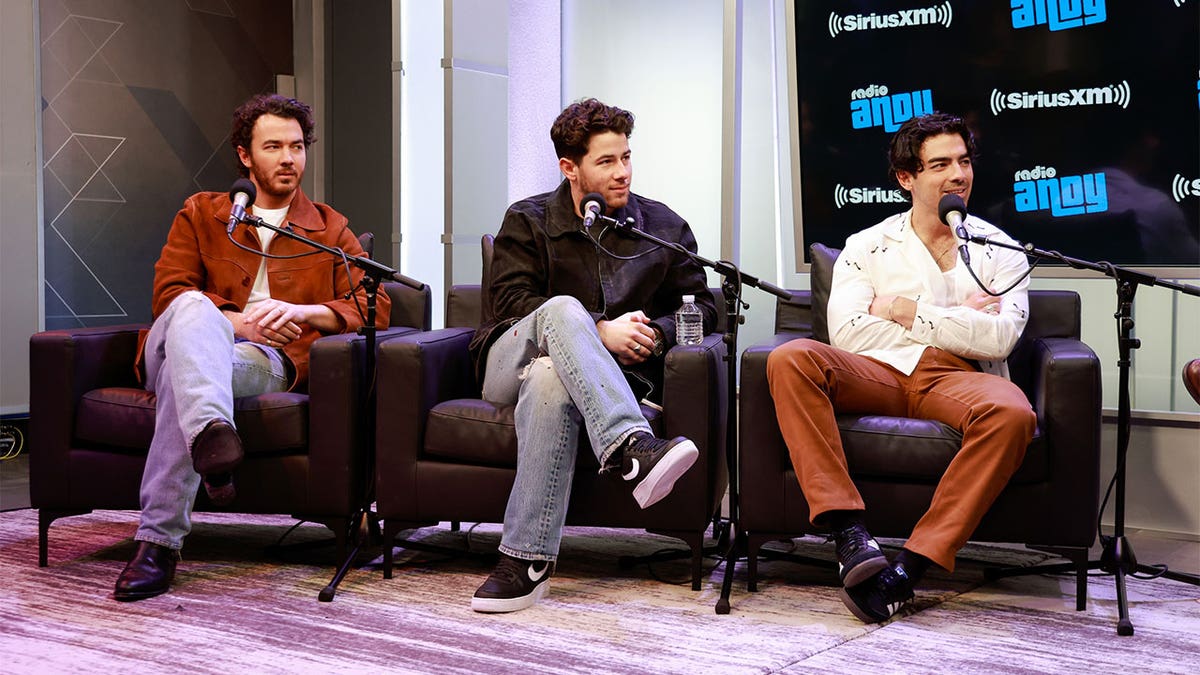 The Jonas Brothers sitting down for a podcast interview.