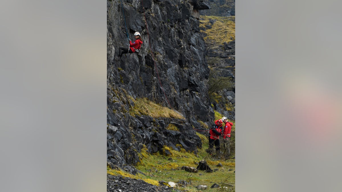 William rappels down a cliff