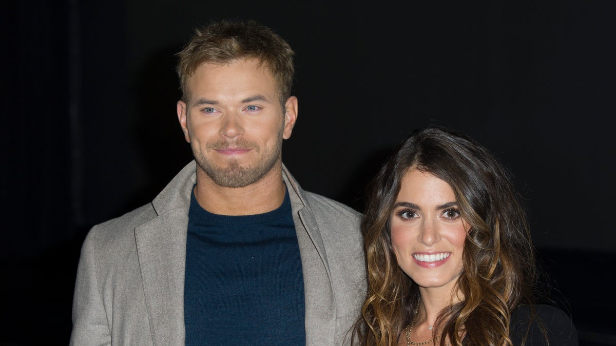 Kellan Lutz and Nikki Reed pose for a photo