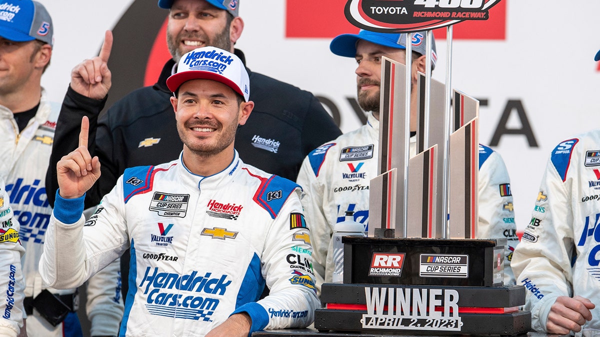 Kyle Larson holds the trophy