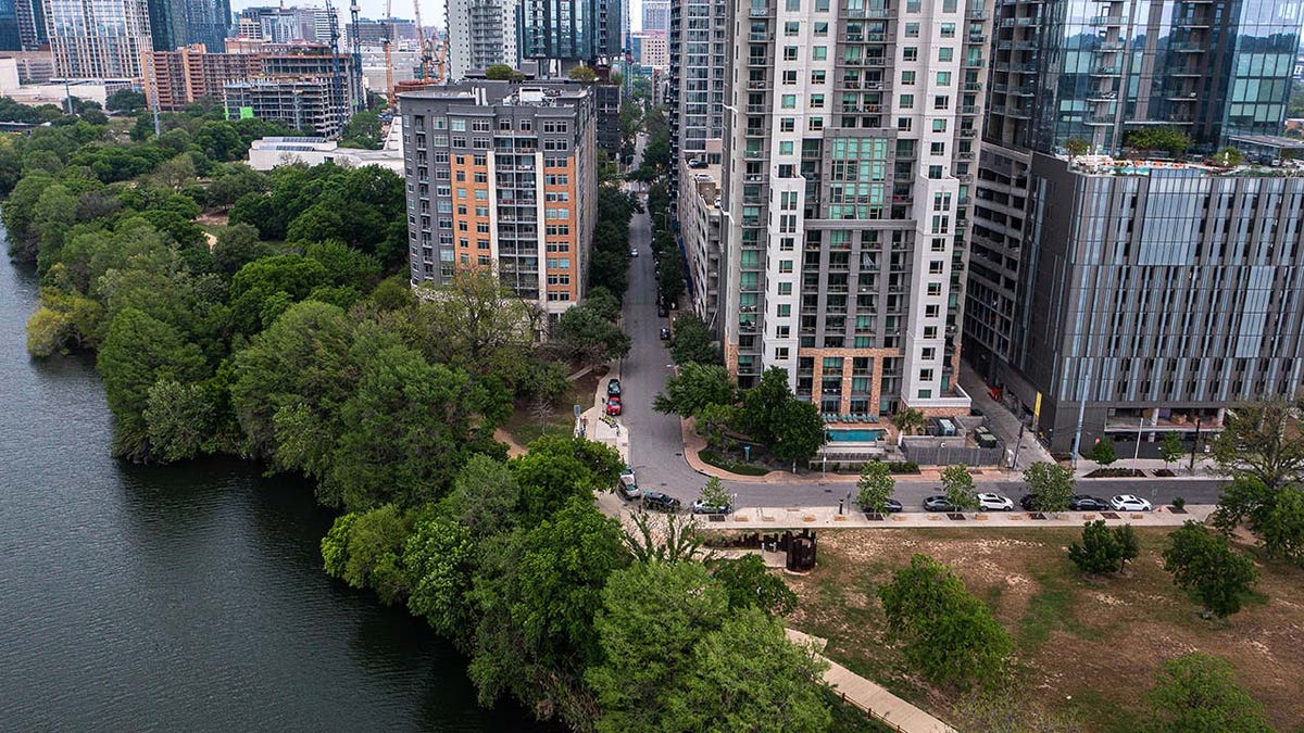 The shore of Lady Bird Lake is less than one hundred feet from the end of Rainey Street