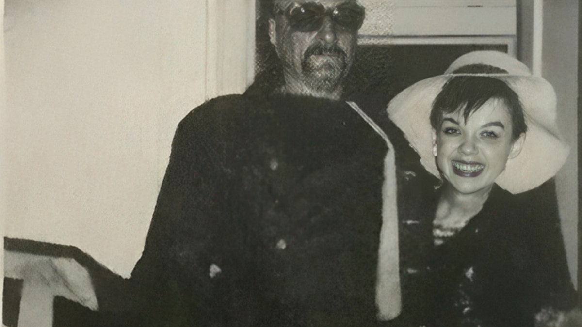 Judy Garland smiling next ot a man wearing a hat