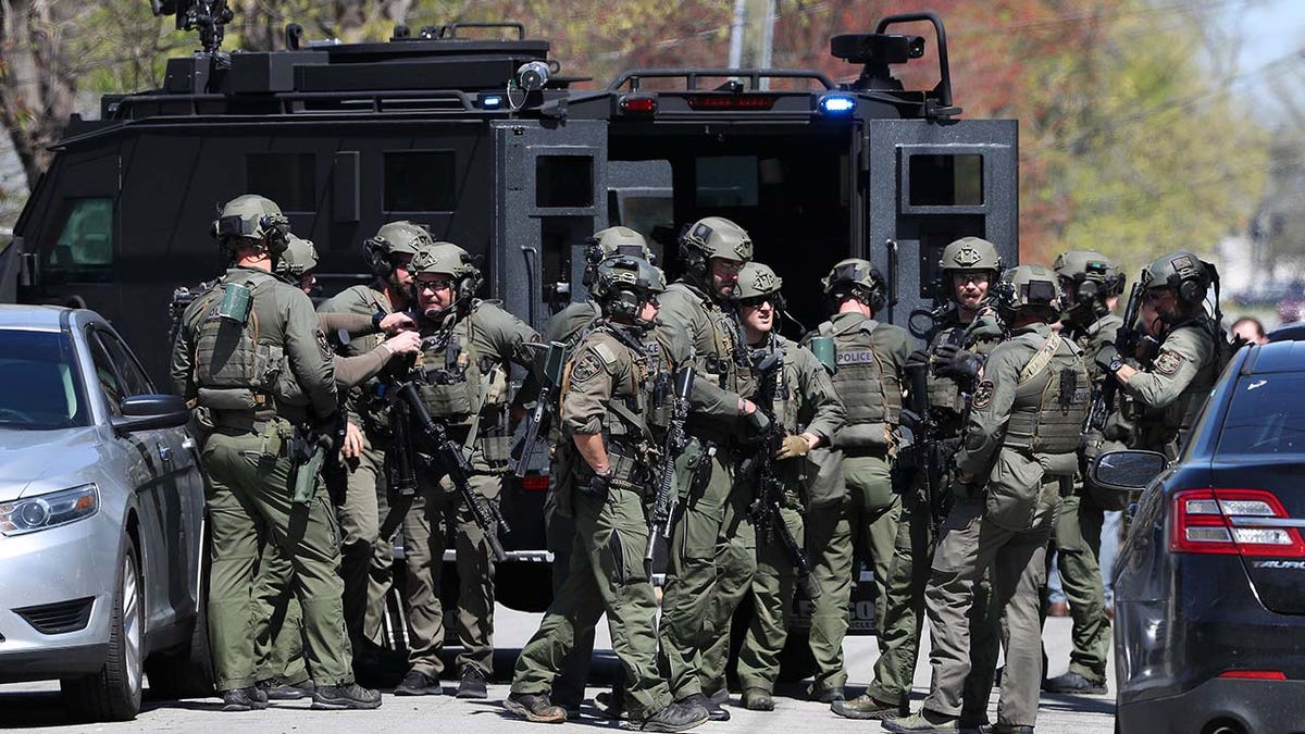 A SWAT unit enters prepares to conduct a raid