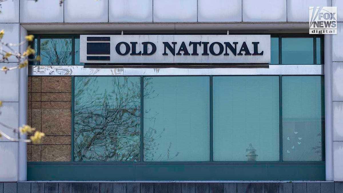 What appears to be bullet holes marked with tape remain visible in the windows of the Old National Bank in downtown Louisville