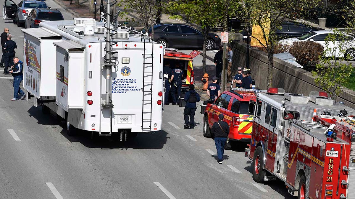 The Louisville metro Police Command Center along with units of the Louisville Fire Department are staged a block from the Old National Bank building in Louisville, Ky