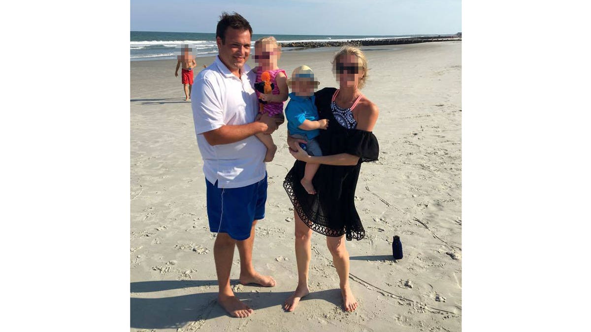 Josh Barrick with his family at the beach.