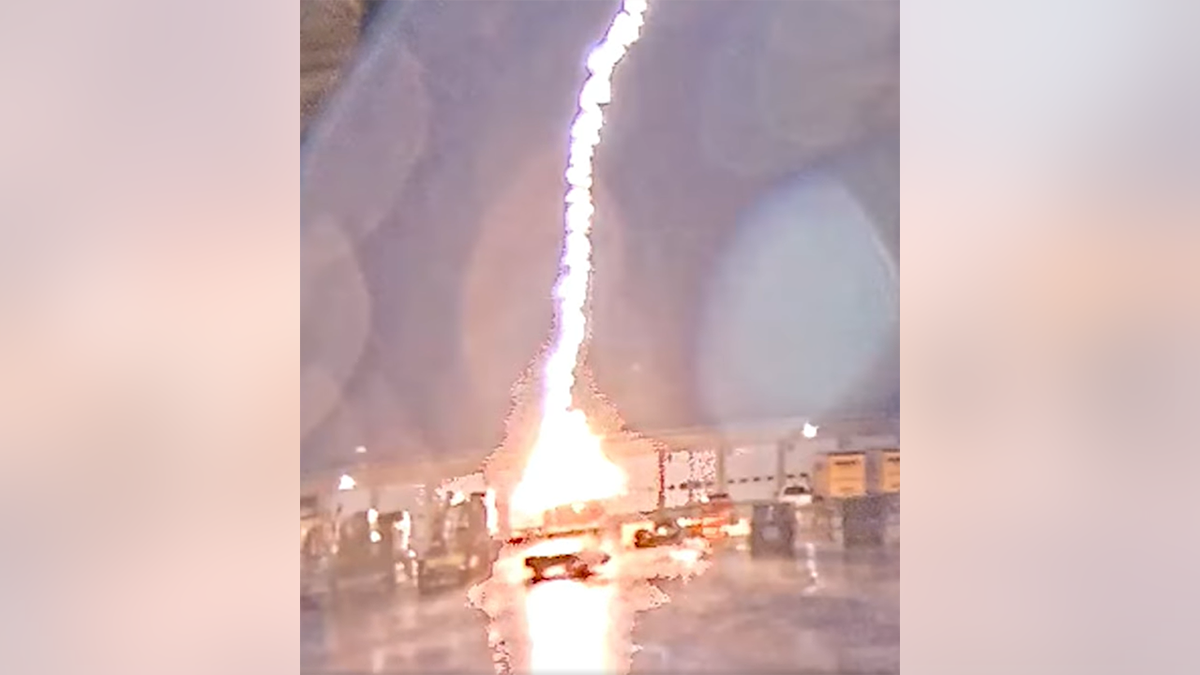 Lightning strike flashes over truck