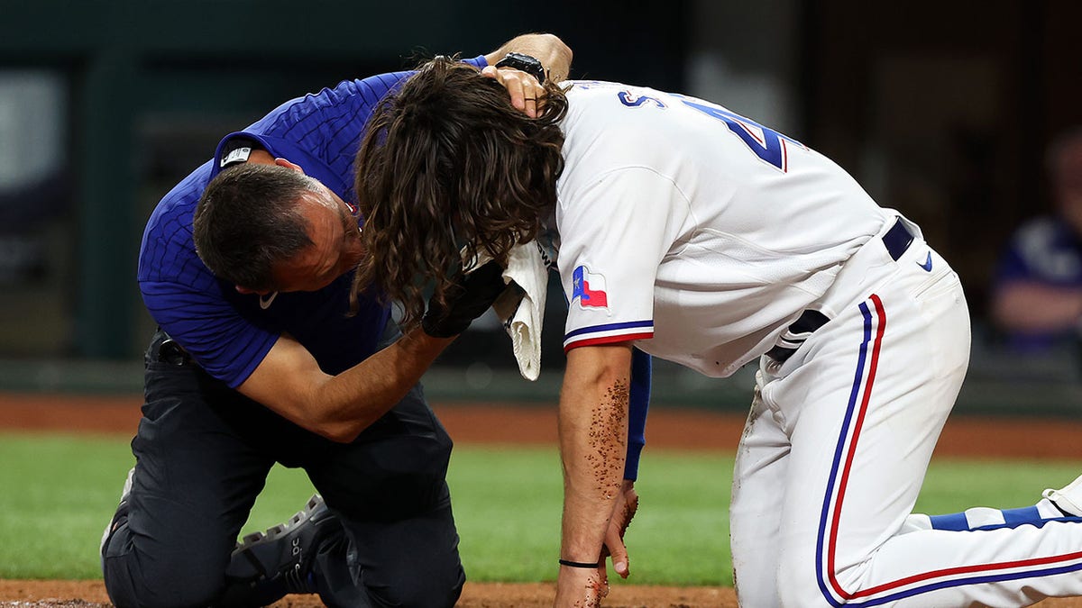 Texas Rangers trainer attends to Josh Smith