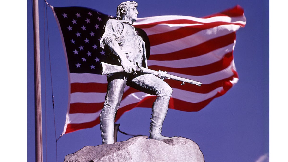 Minuteman statue with U.S. flag