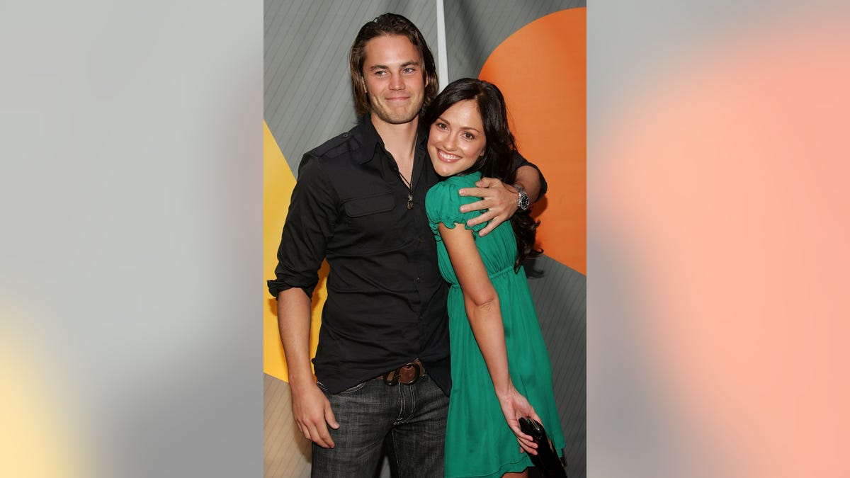 Minka Kelly and Taylor Kitsch pose for a photo