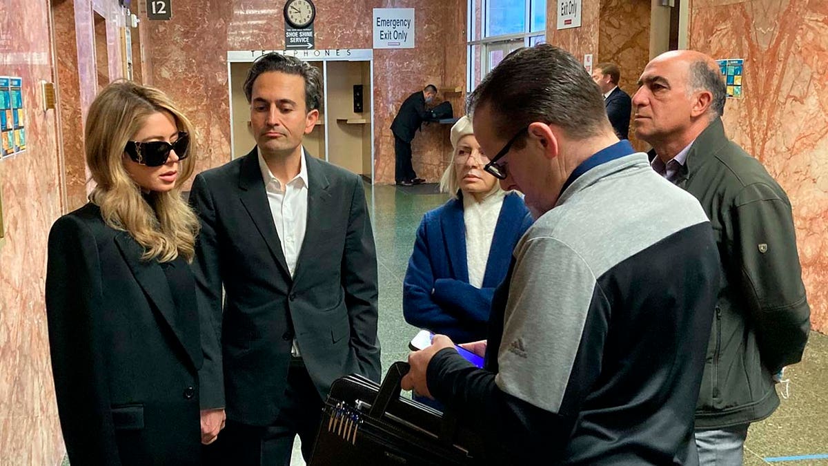 Khazar Elyassnia, left, stands in the Hall of Justice in San Francisco on Friday, April 14, 2023, ahead of an appearance by her brother, Nima Momeni, who has been charged with murder in the death of tech entrepreneur Bob Lee