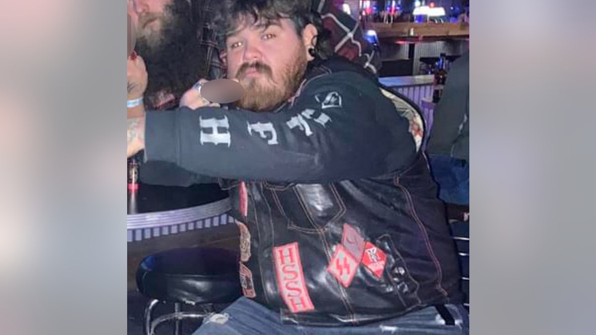 Eric Oberholtzer wearing biker patches at a bar