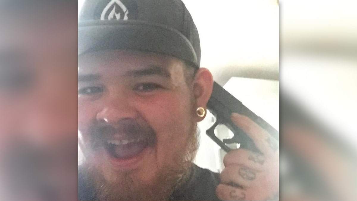 Eric Oberholtzer in a selfie with a gun held against his own head
