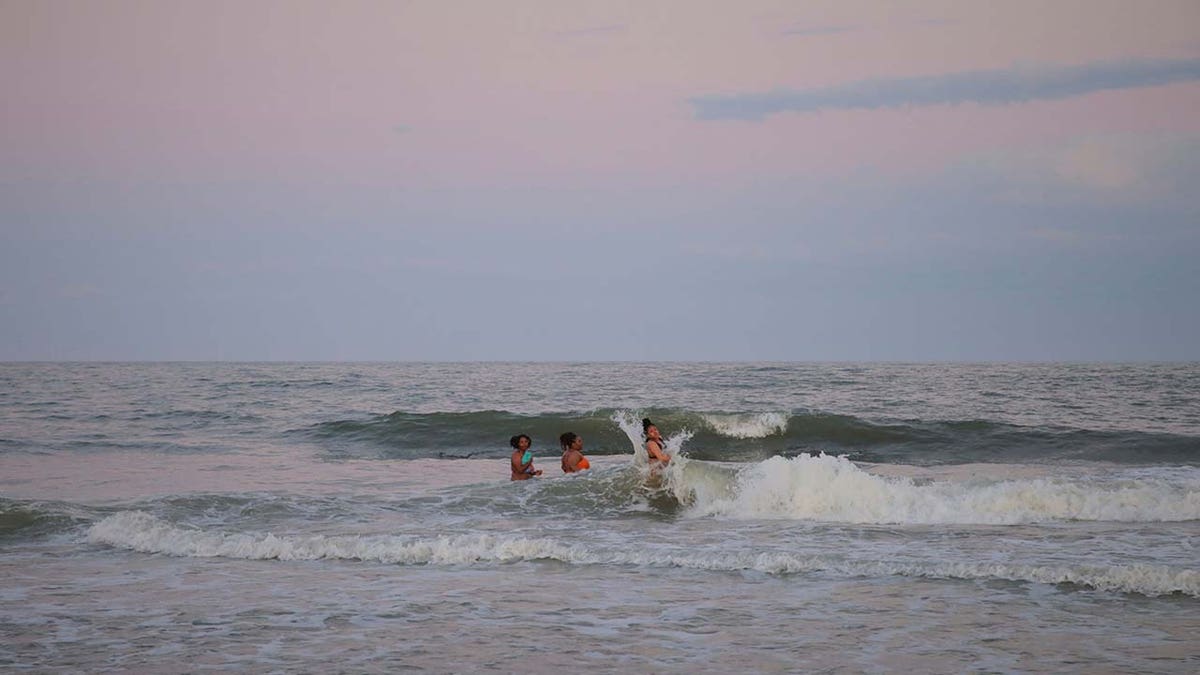 People spending time with their friends at the edge of the water during Orange Crush o