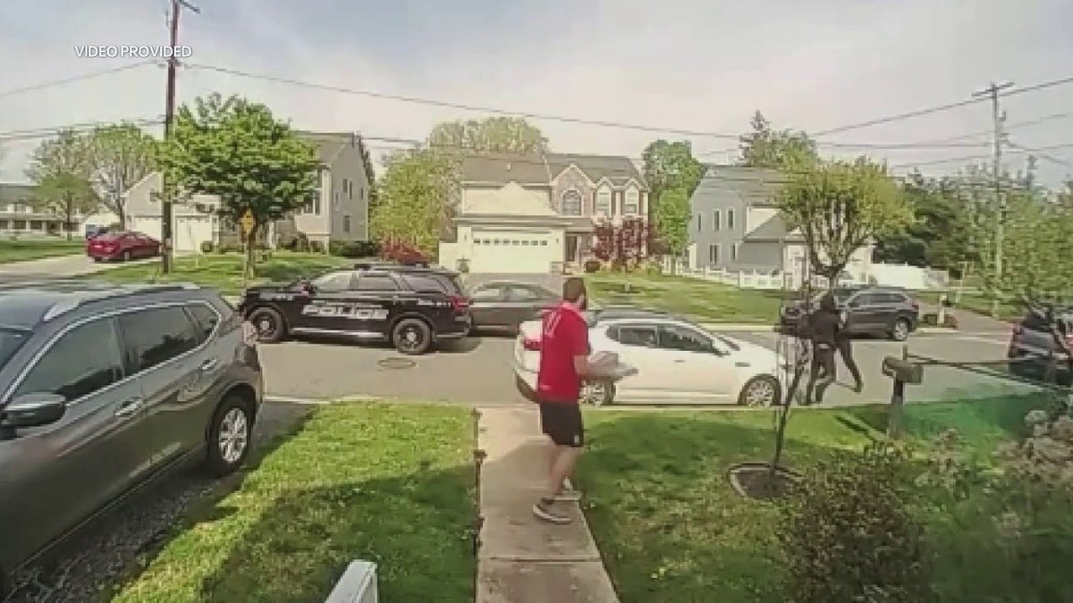 pizza delivery man watching police apprehend suspect