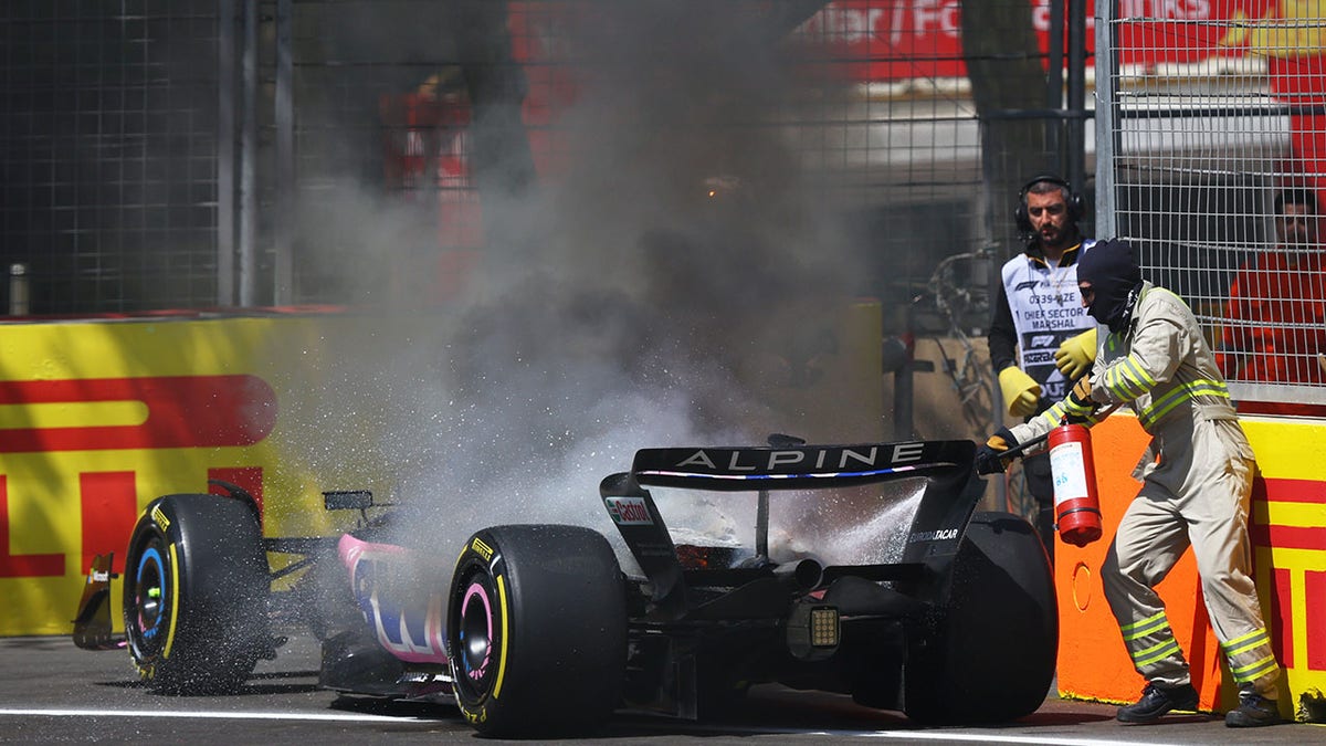 Track marshals put out the fire in the car of Pierre Gasly 